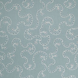 White embroidery pattern on a blue background.
