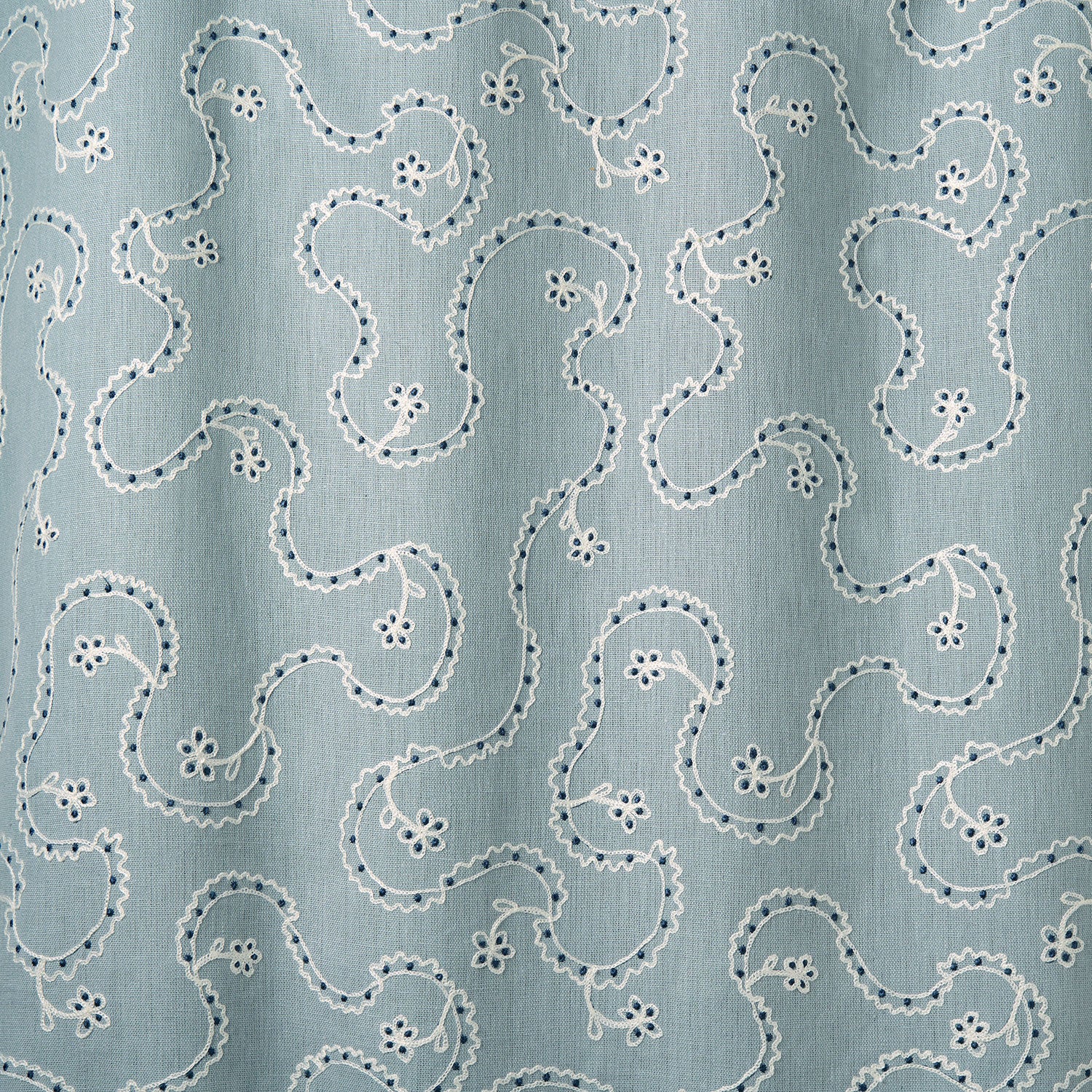 White embroidery pattern on a blue background.