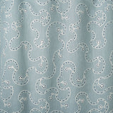 White embroidery pattern on a blue background.