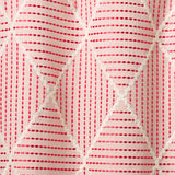 Geometric embroidery pattern with white lines on a pink background.