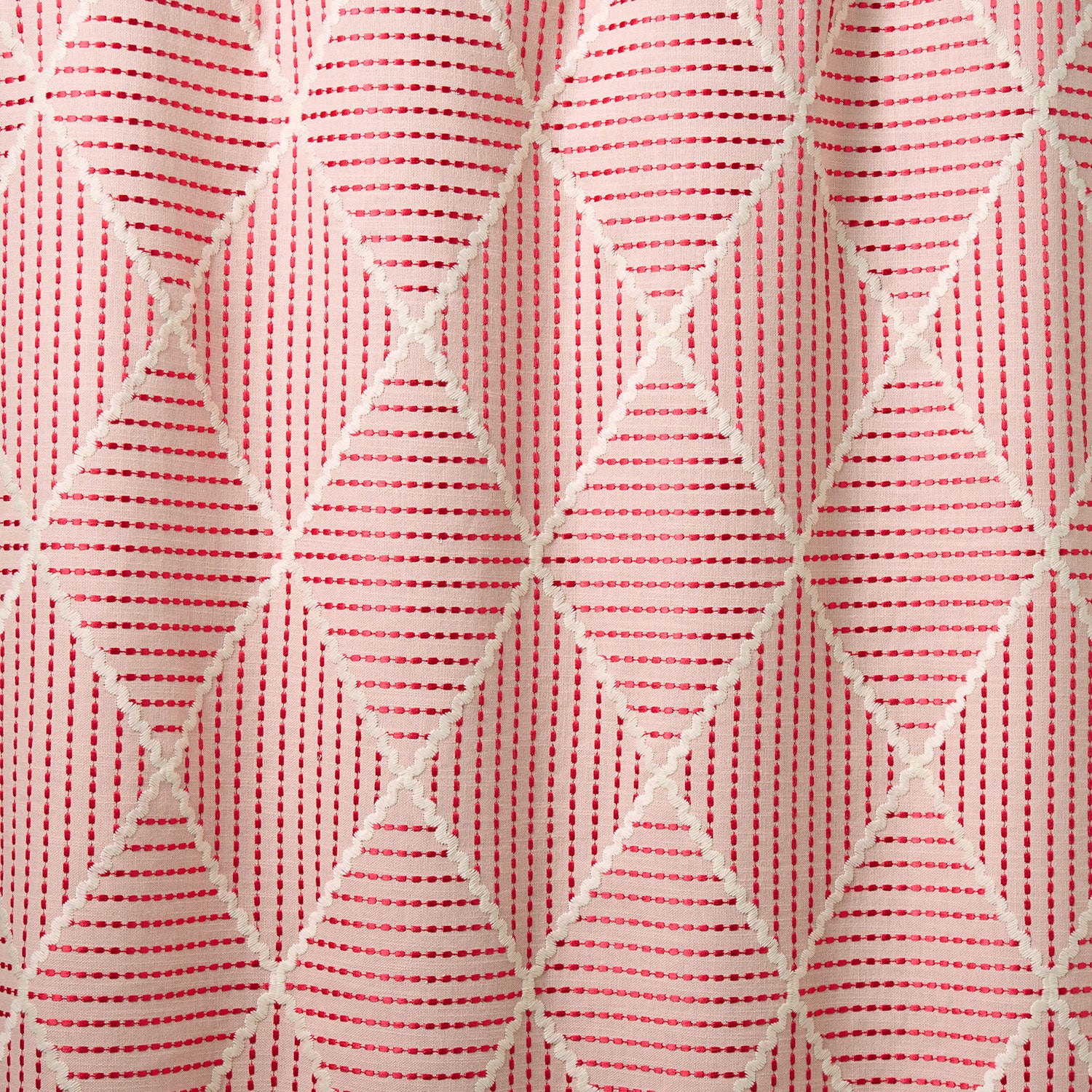 Geometric embroidery pattern with white lines on a pink background.