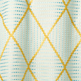 Geometric embroidery pattern with yellow and blue lines on a textured background.