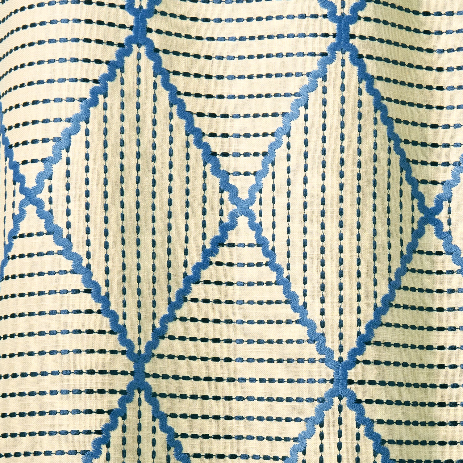 Geometric embroidery pattern with blue and beige lines on a textured background