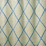 Geometric embroidery pattern with blue and beige lines on a textured background