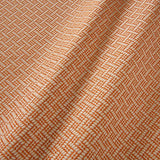 A woven fabric sample in orange and off-white featuring a trellis pattern.