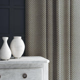 Curtain in blue and off-white woven fabric featuring a trellis pattern.