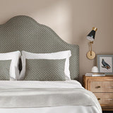 Headboard upholstered in a blue and off-white woven fabric featuring a trellis pattern.