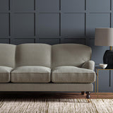 Sofa upholstered in a blue and off-white woven fabric featuring a trellis pattern.