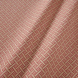 A woven fabric sample in red and off-white featuring a trellis pattern.