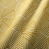 A woven fabric sample in yellow and off-white featuring a geometric pattern.