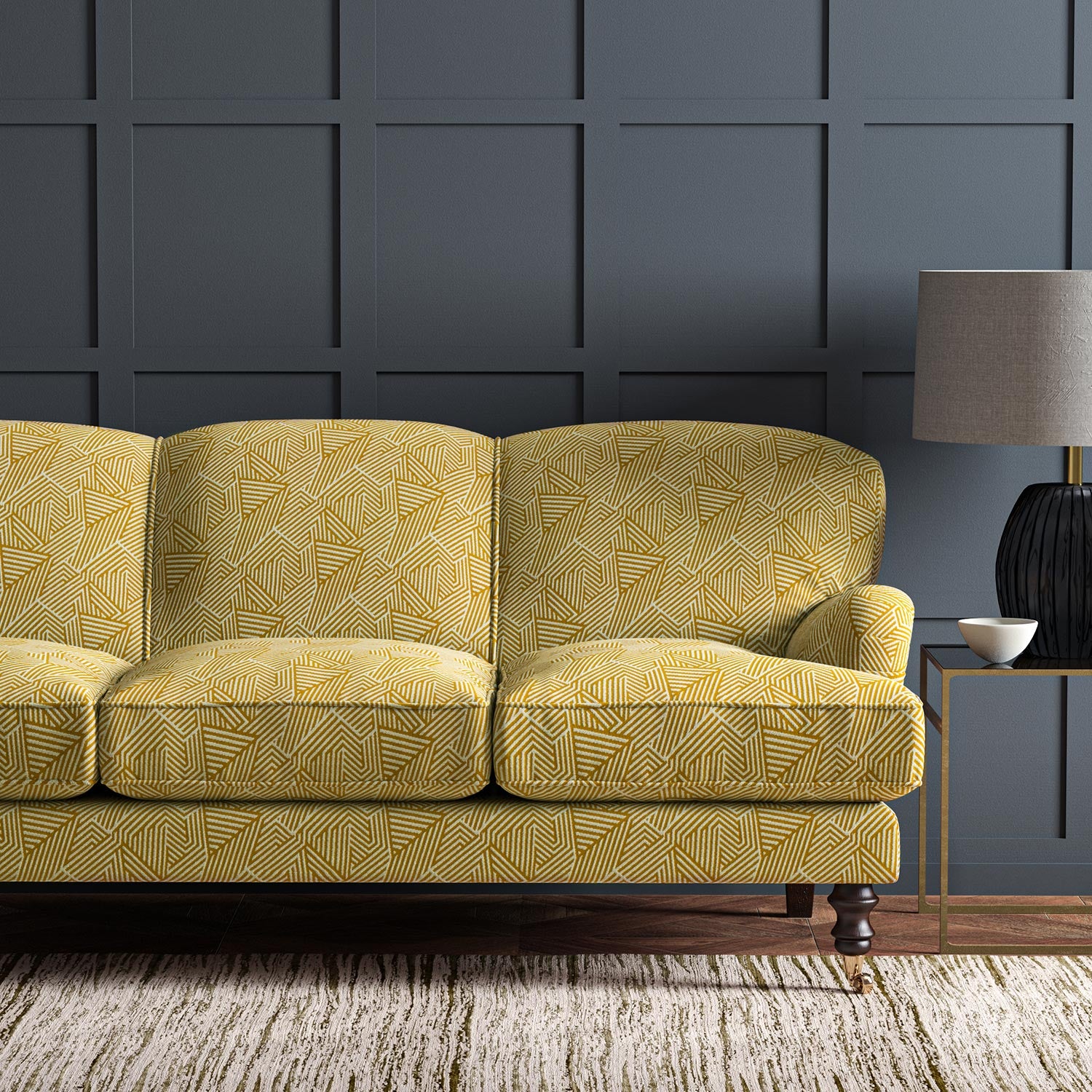 Sofa upholstered in a yellow and off-white woven fabric featuring a geometric pattern.