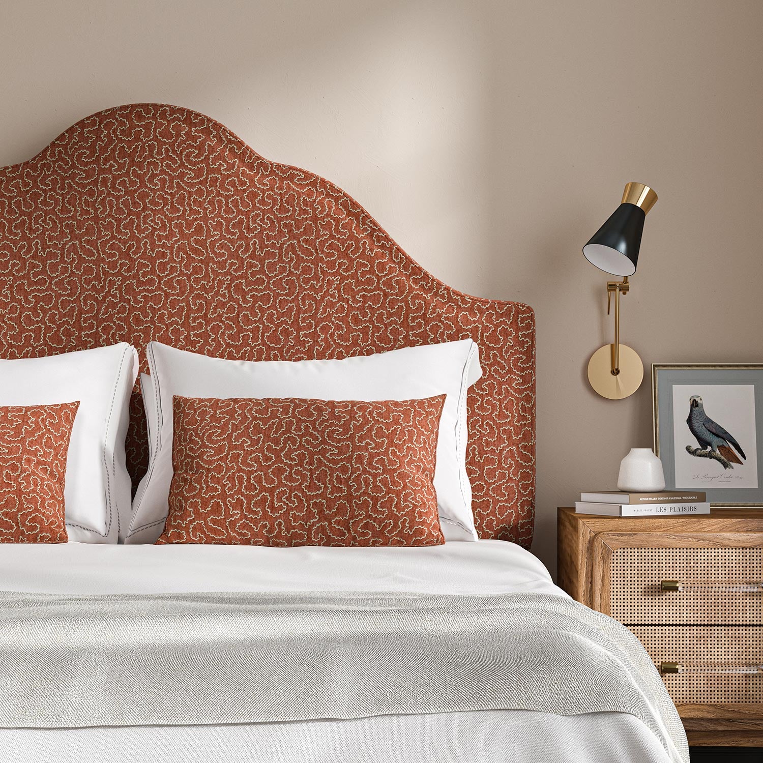 Headboard upholstered in a red and off-white woven fabric featuring a wavy pattern.