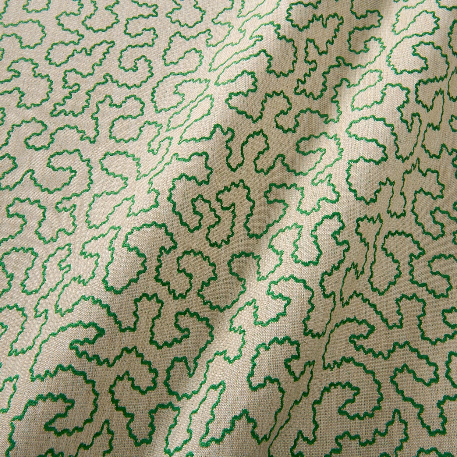 A woven fabric sample in green and off-white featuring a wavy pattern.