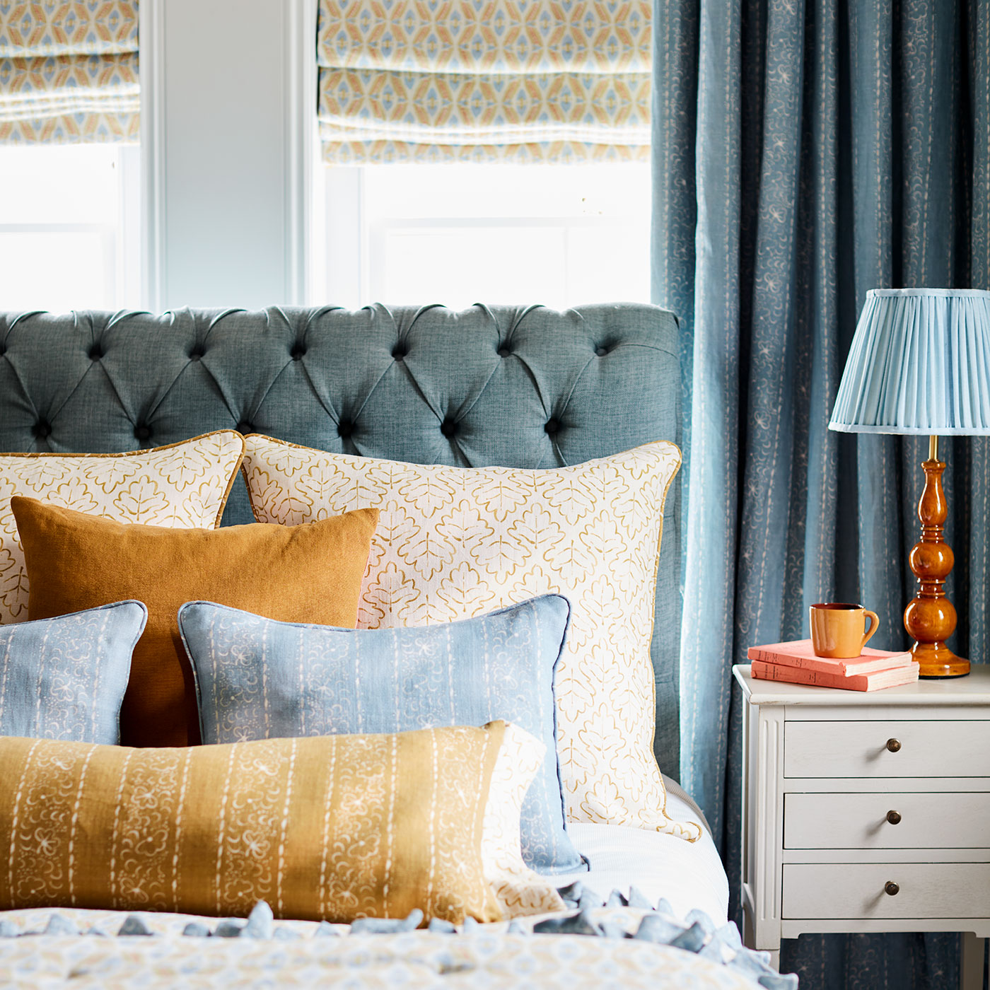 Cushion with a delicate pattern of moons and star-like dots in yellow and cream