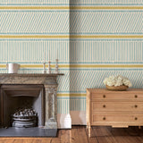 Sitting room with a blue and yellow wallpaper with a combination of tonal stripes, zigzags, and matching colour bands.