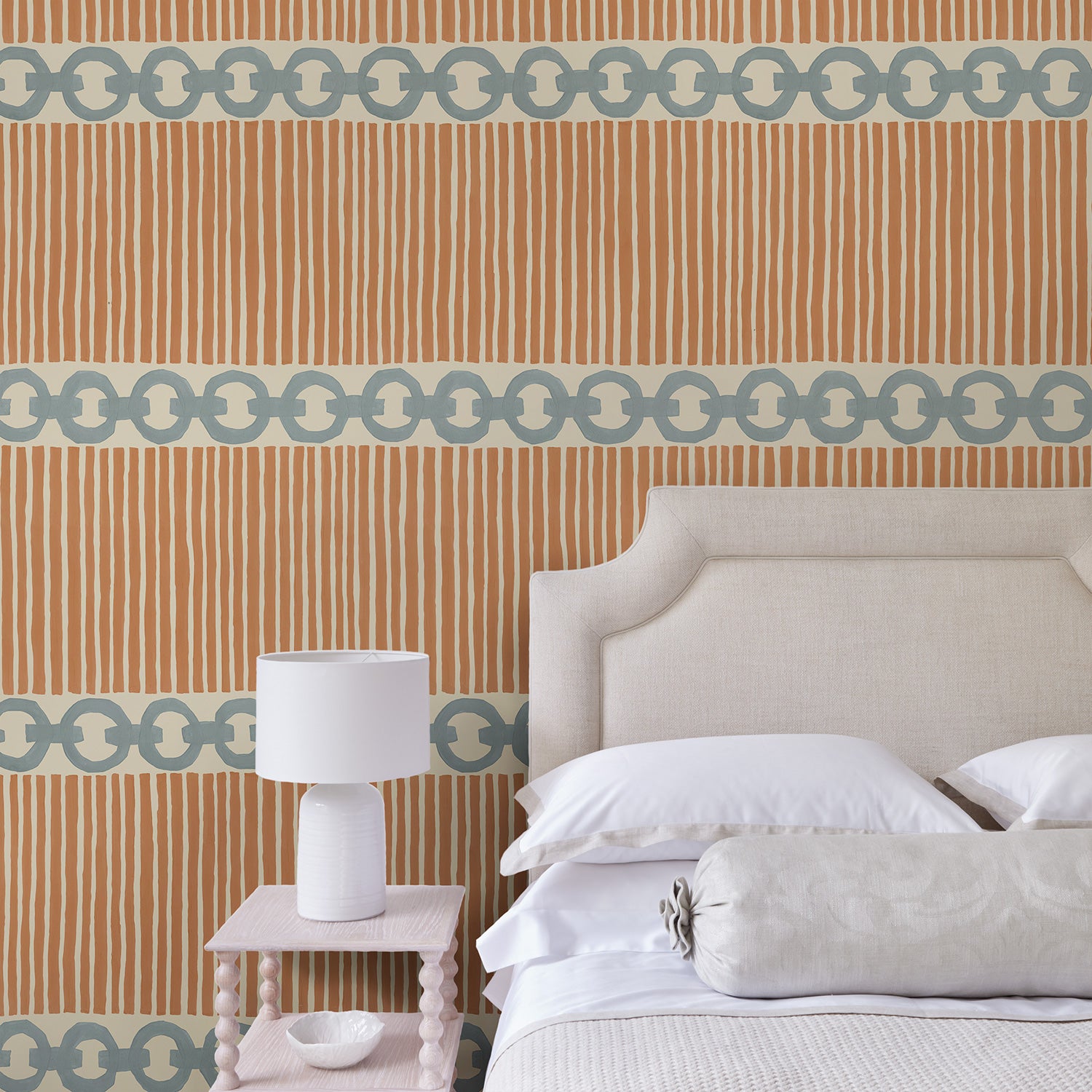 Bedroom with a chain-link wallpaper with different-sized blue and brown stripes.