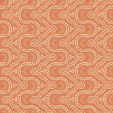 Sitting room with a orange geometric wallpaper.