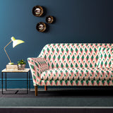 Velvet sofa upholstered in a geometric velvet upholstery fabric in peach and green colours with a stain resistant finish