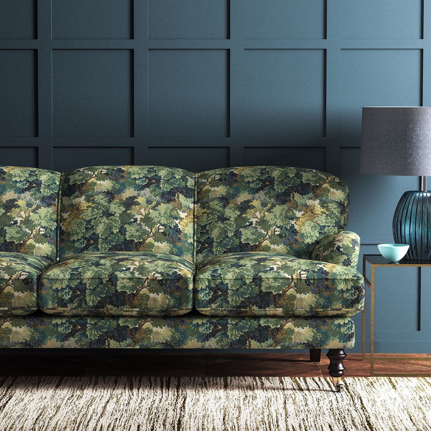 Sofa covered in a printed velvet fabric featuring a classic oak leaf design in green.