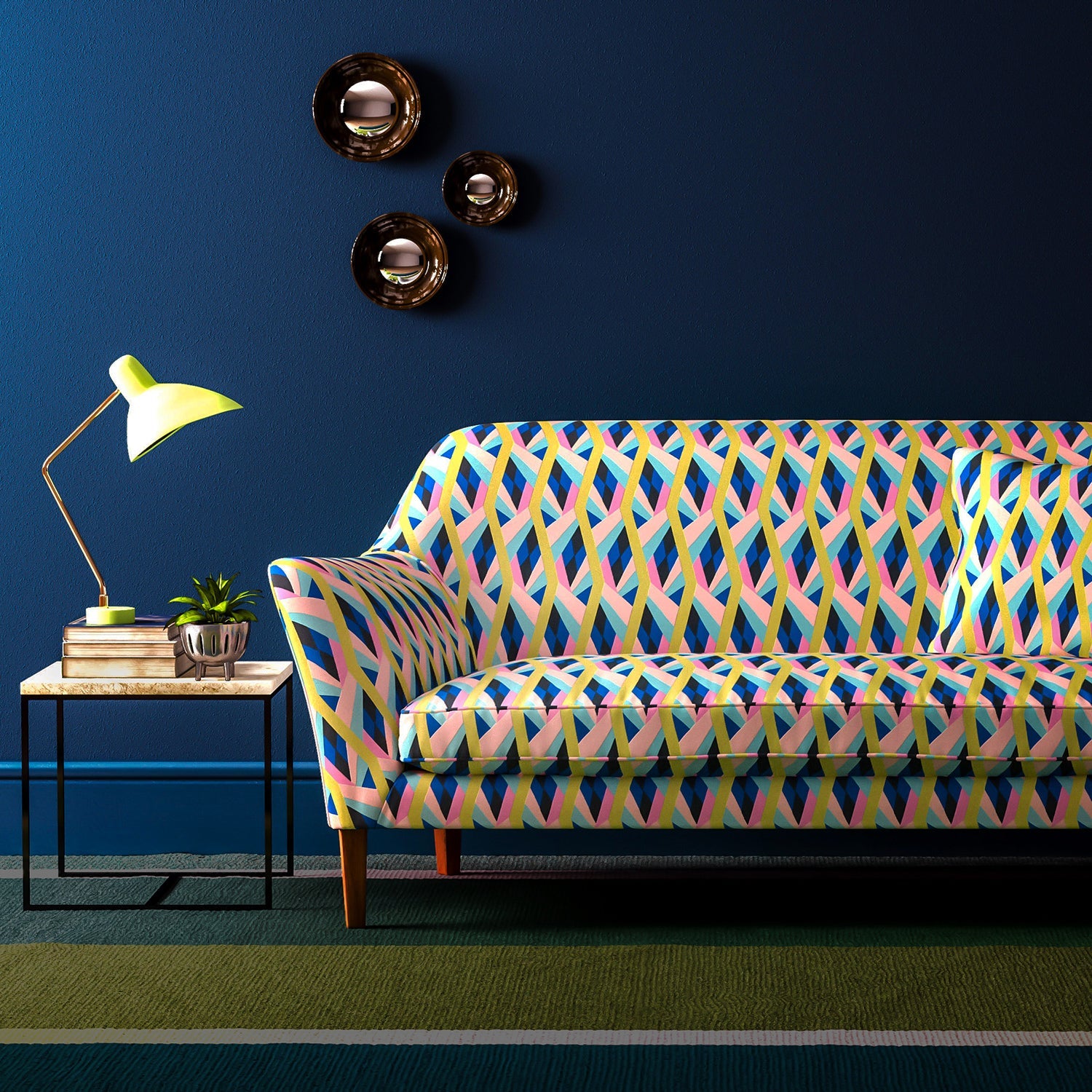 Sofa covered in a velvet upholstery fabric with a bold, geo pattern.