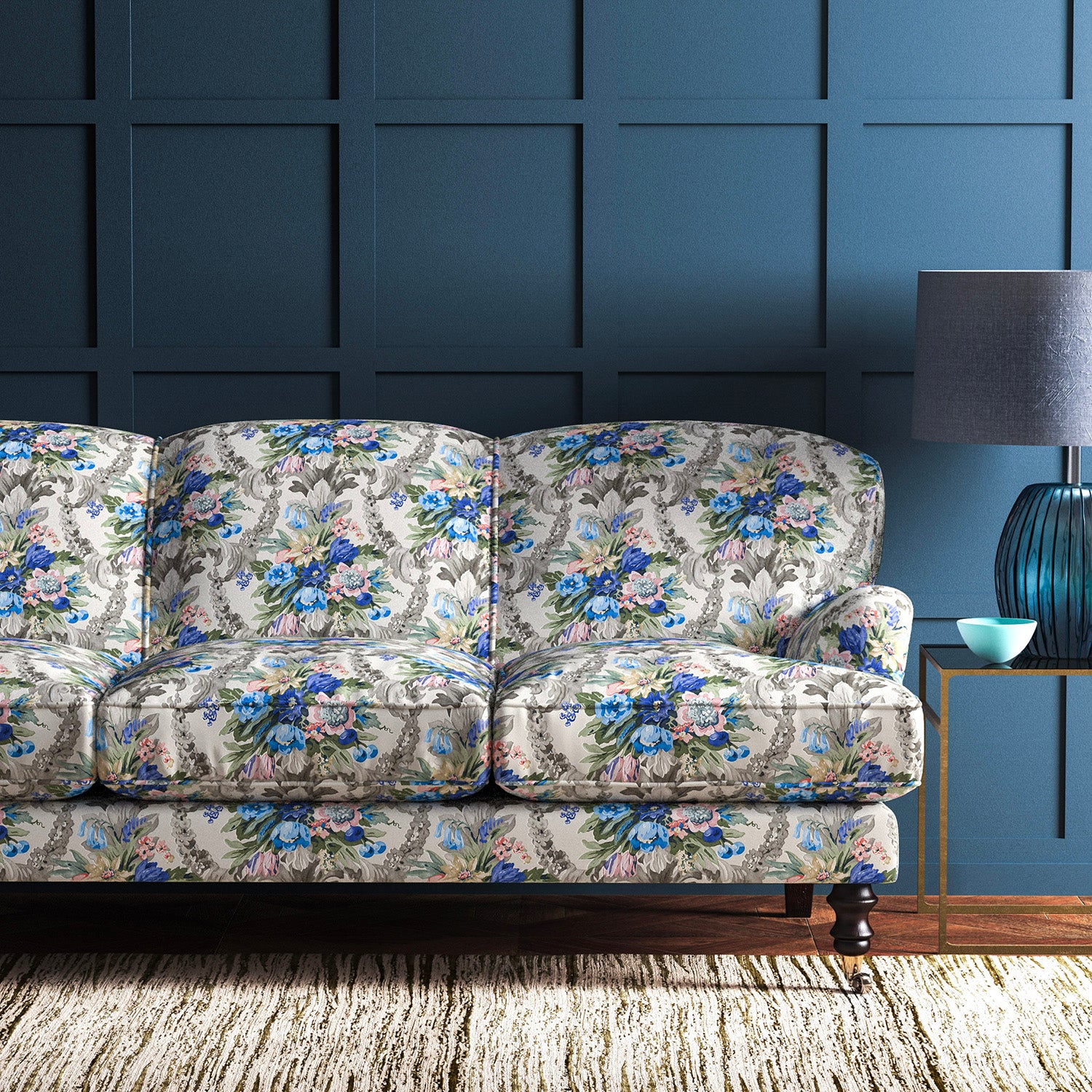 Sofa upholstered in a velvet upholstery fabric with stain resistant finish and vibrant colourful flower bouquet