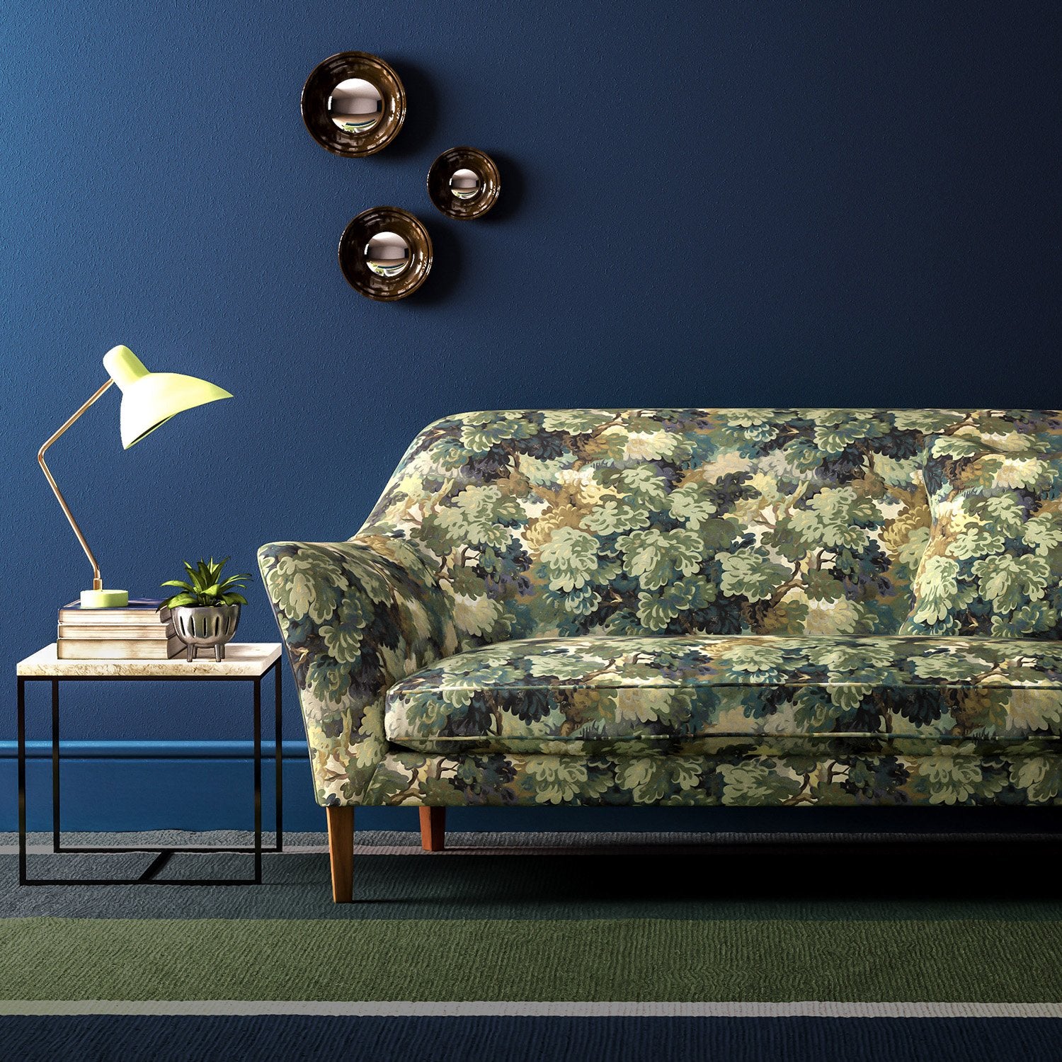 Sofa covered in a printed velvet fabric featuring a classic oak leaf design in green.