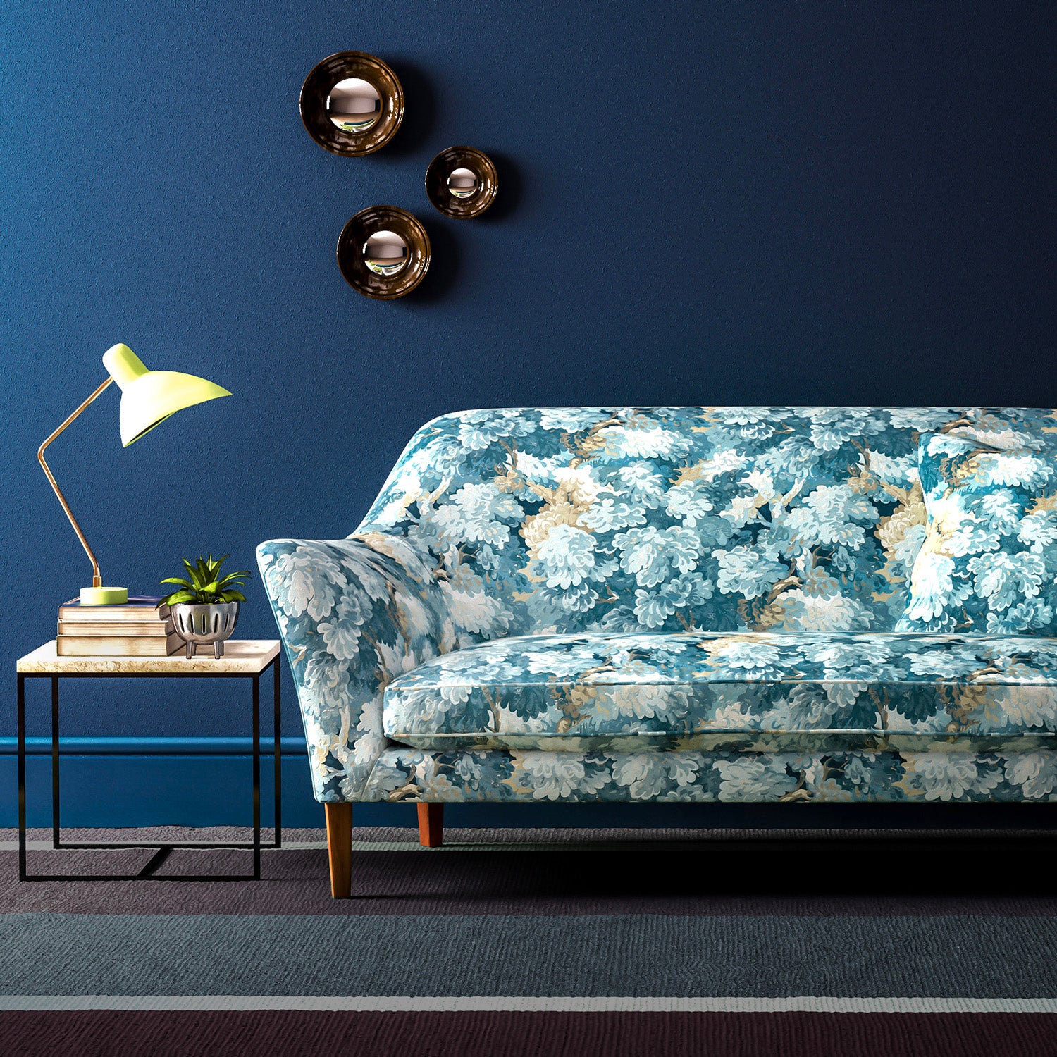 Sofa covered in a printed velvet fabric featuring a classic oak leaf design in Cornflower.