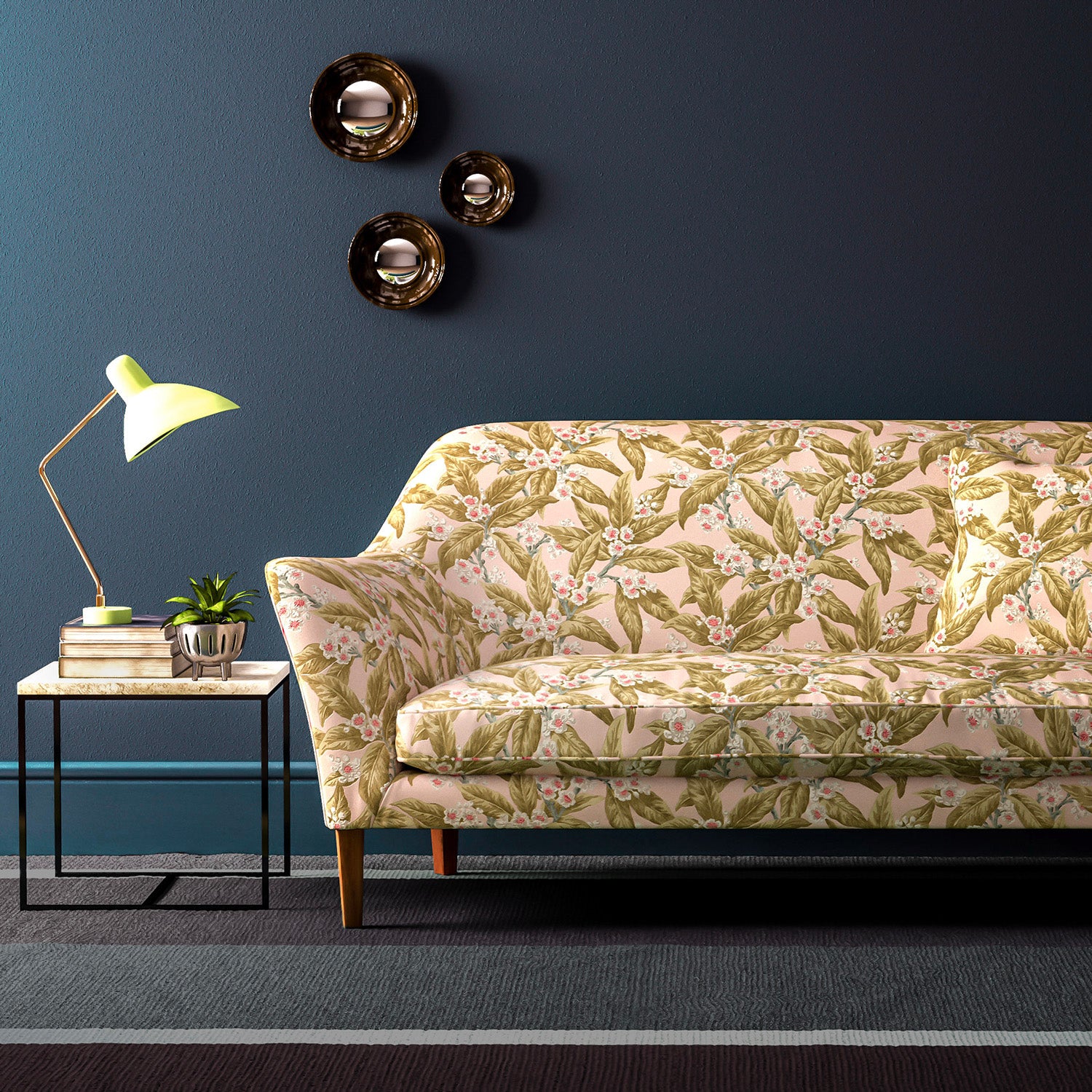 Sofa covered in a velvet upholstery fabric in a peach and ochre leaf and blossom design.
