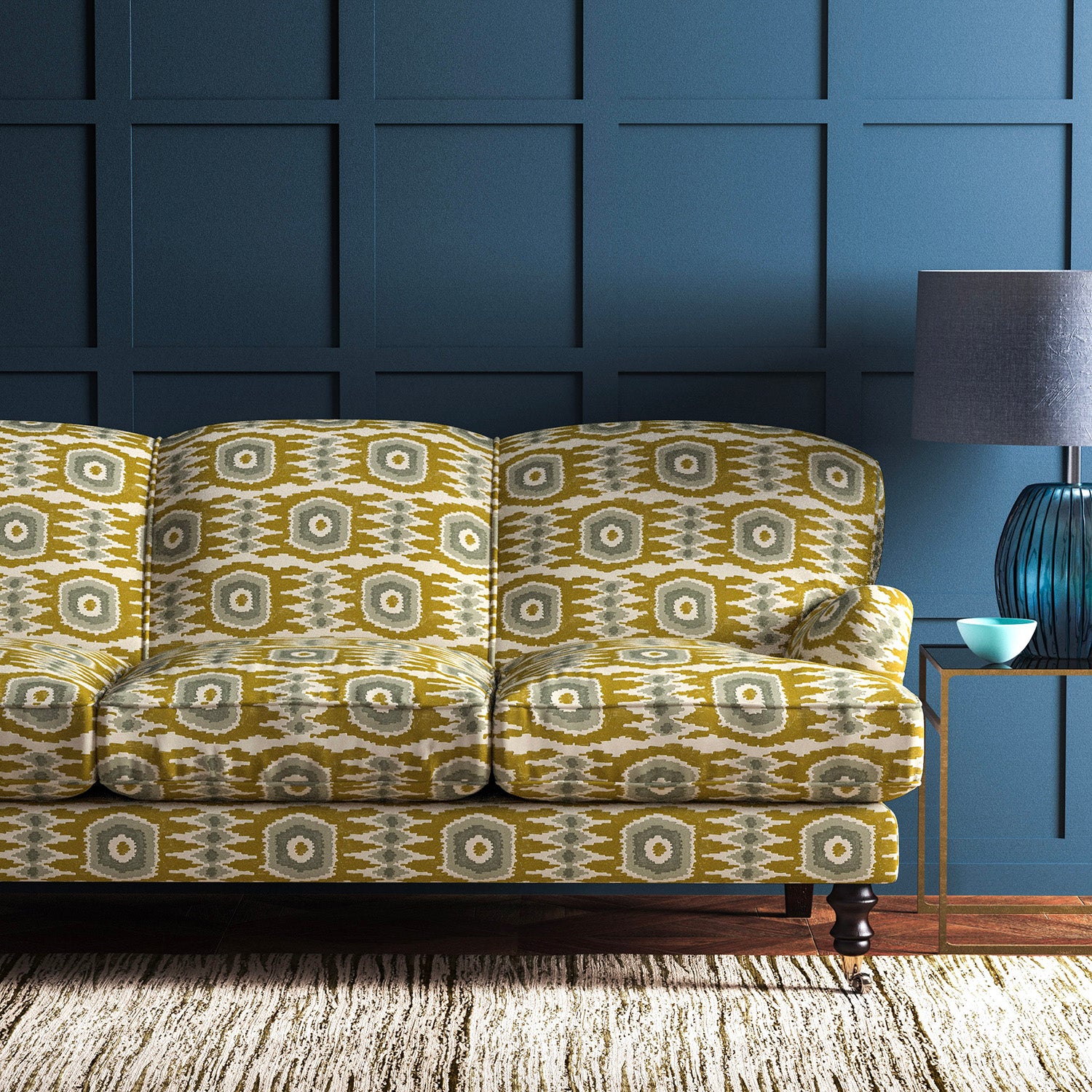 Sofa covered in a printed velvet upholstery fabric featuring a fun, jazzy pattern in Ochre.