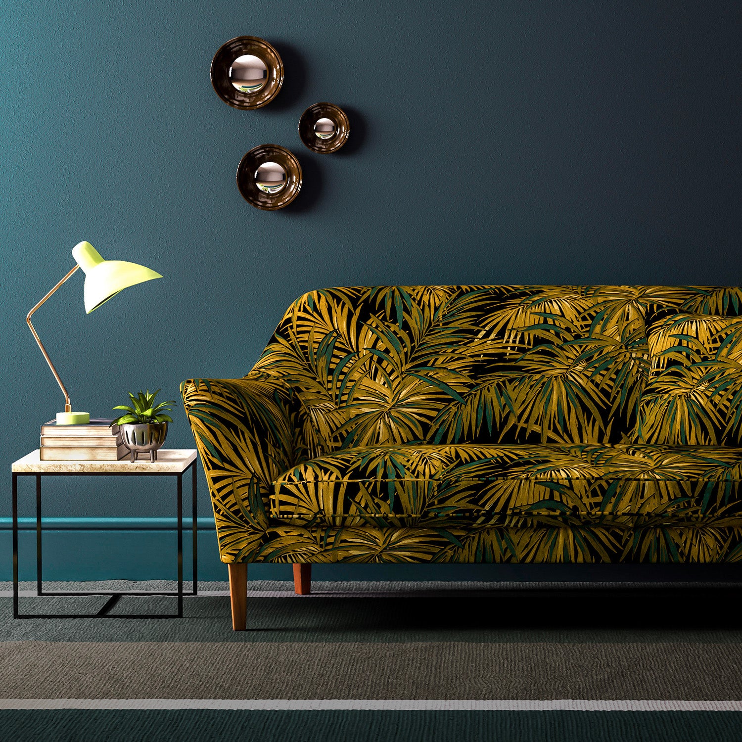 Sofa upholstered in green and gold printed velvet upholstery fabric with palm leaf design.