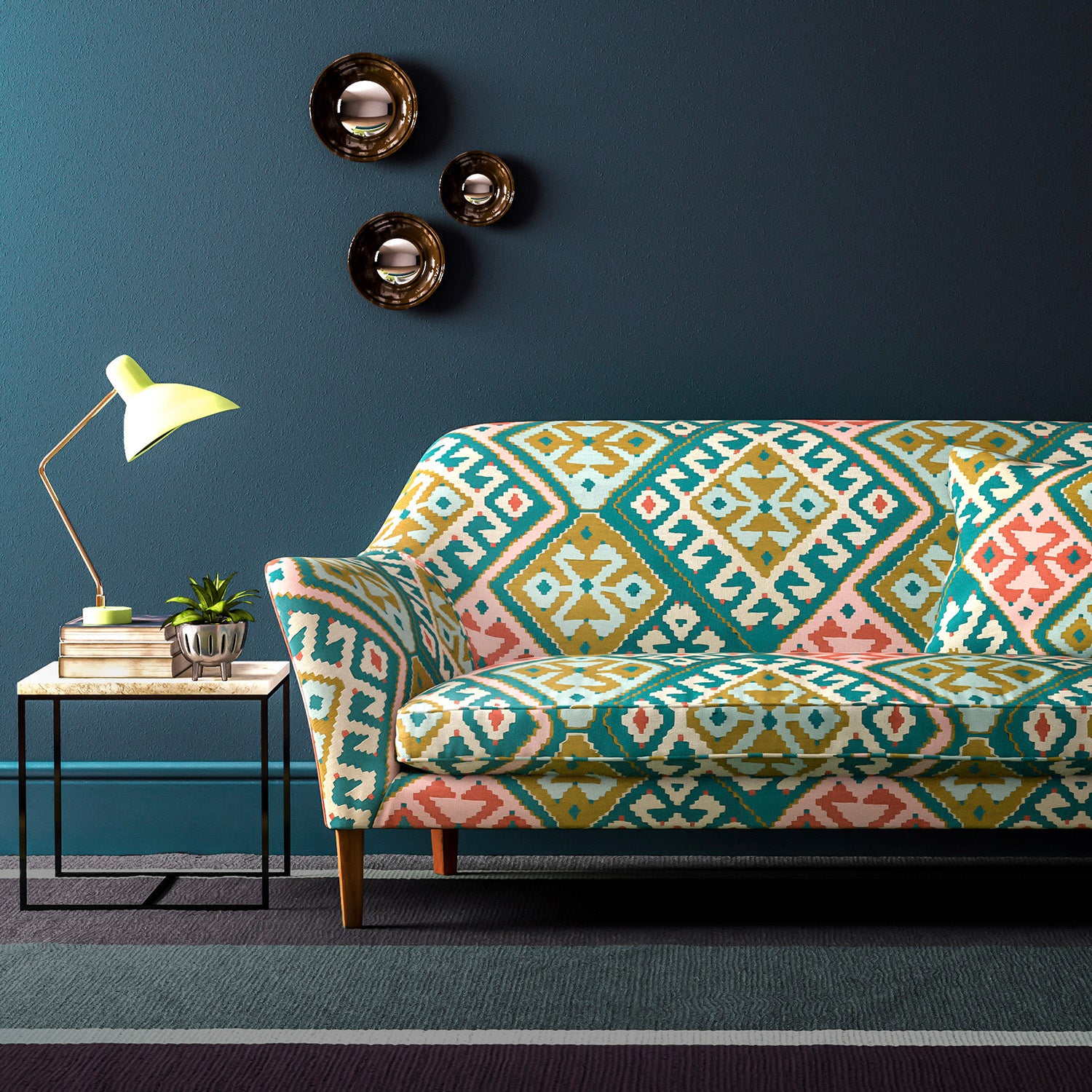 Sofa upholstered in a teal-pink velvet upholstery fabric with a kilim design with a stain resistant finish.