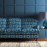 Sofa covered in a printed velvet upholstery fabric featuring a fun, jazzy pattern in navy.
