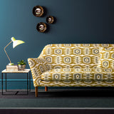 Sofa covered in a printed velvet upholstery fabric featuring a fun, jazzy pattern in Ochre.