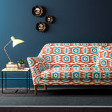 Velvet sofa upholstered in a orange and blue velvet upholstery fabric with abstract print and stain resistant finish