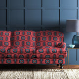 Sofa covered in a printed velvet upholstery fabric featuring a fun, jazzy pattern in Rosewood.
