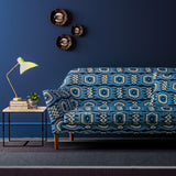 Sofa covered in a printed velvet upholstery fabric featuring a fun, jazzy pattern in navy.