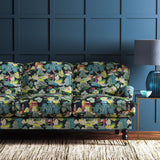 Sofa covered in a printed velvet fabric featuring a Japanese-style toile in blue and yellow.
