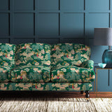 Sofa covered in a printed velvet fabric featuring a Japanese-style toile in green.