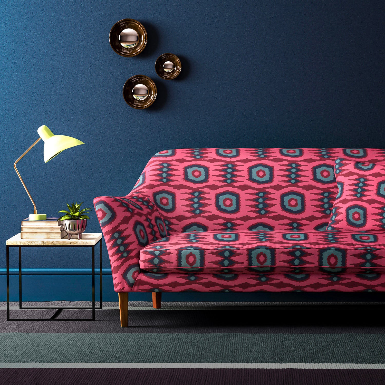 Sofa covered in a printed velvet upholstery fabric featuring a fun, jazzy pattern in Berry.