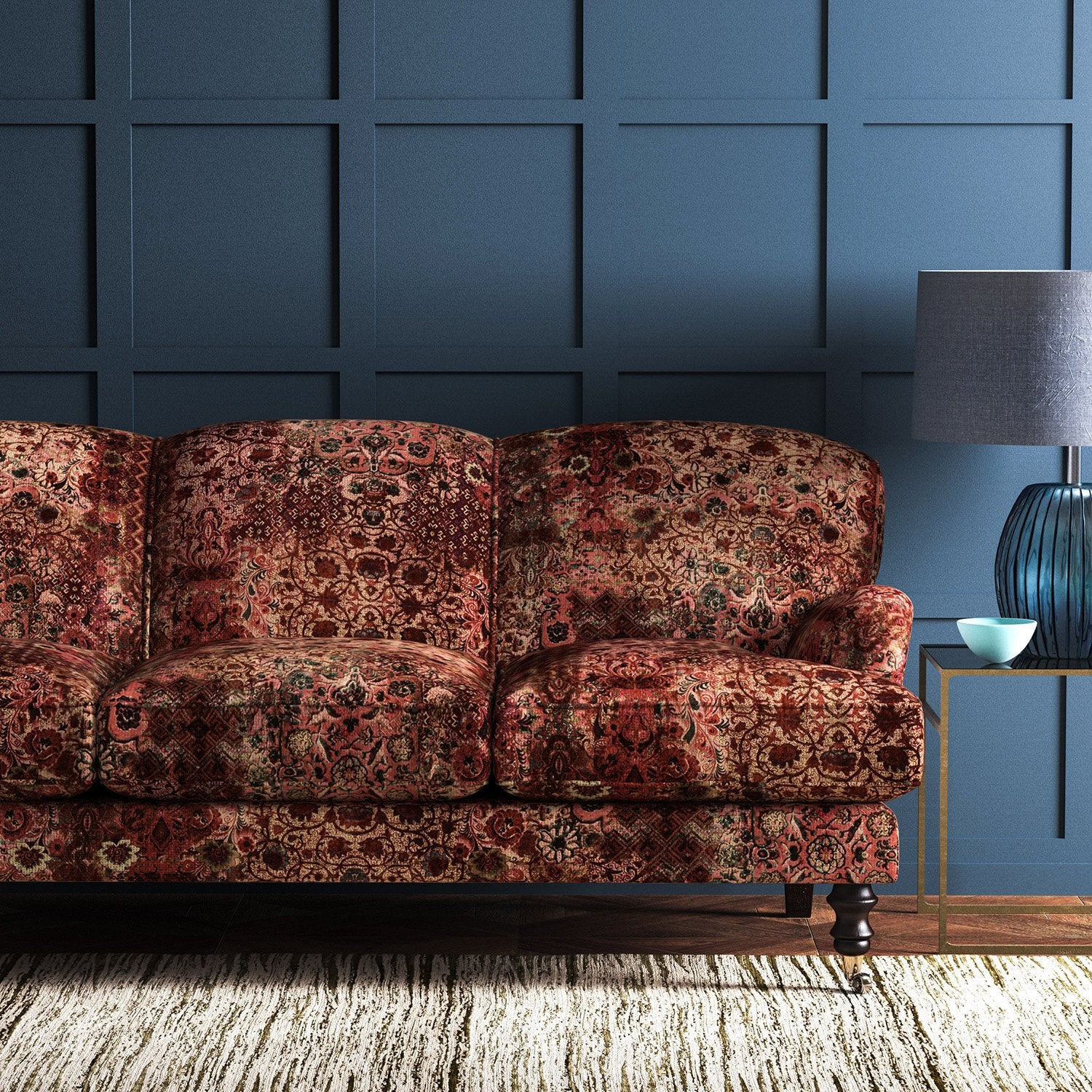 Sofa covered in a velvet upholstery fabric with an antique carpet-style design.