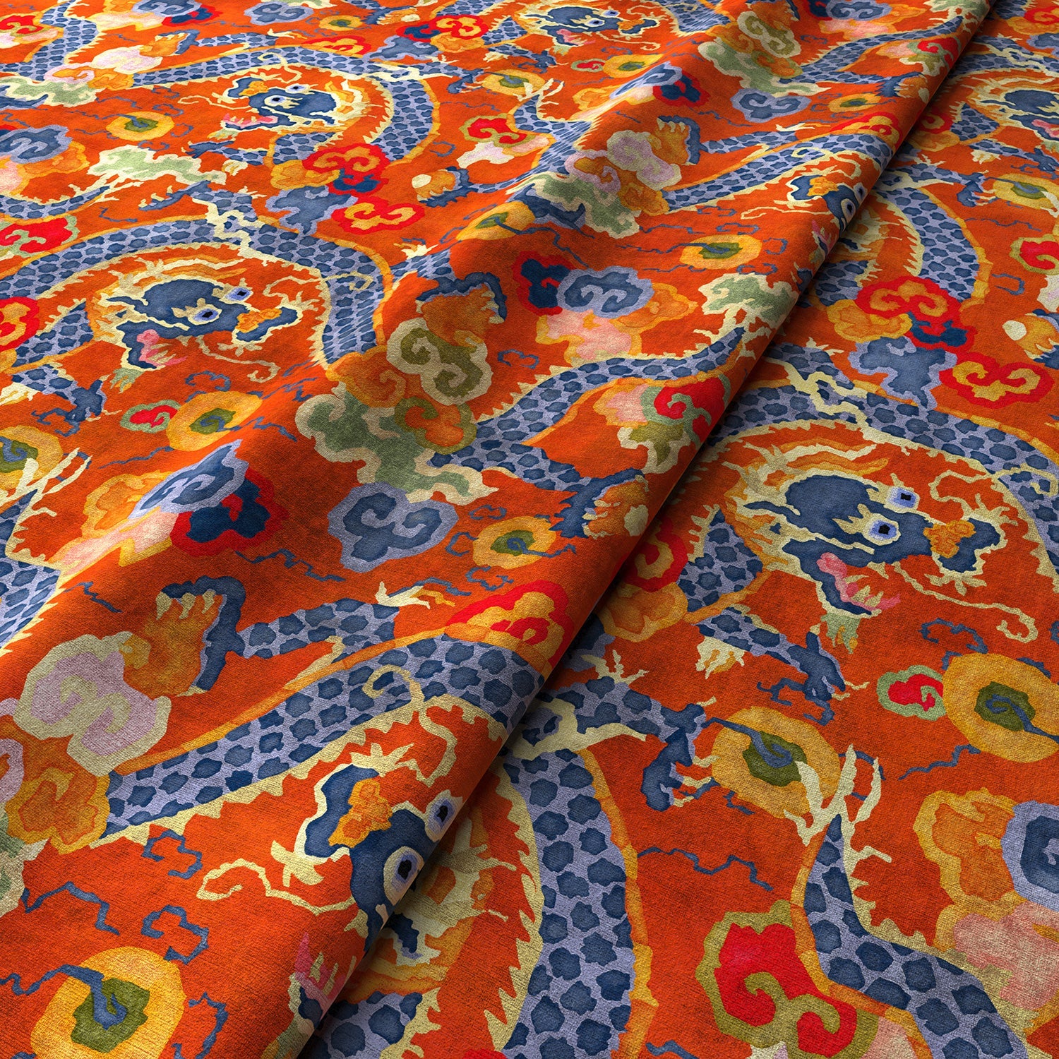 Printed velvet fabric with intricate mirror dragon design in orange colours, for upholstery and curtain use.