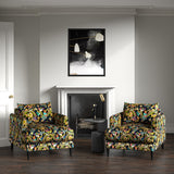 Velvet armchairs upholstered in a printed velvet fabric with a intricate mirror dragon design in multicolours.