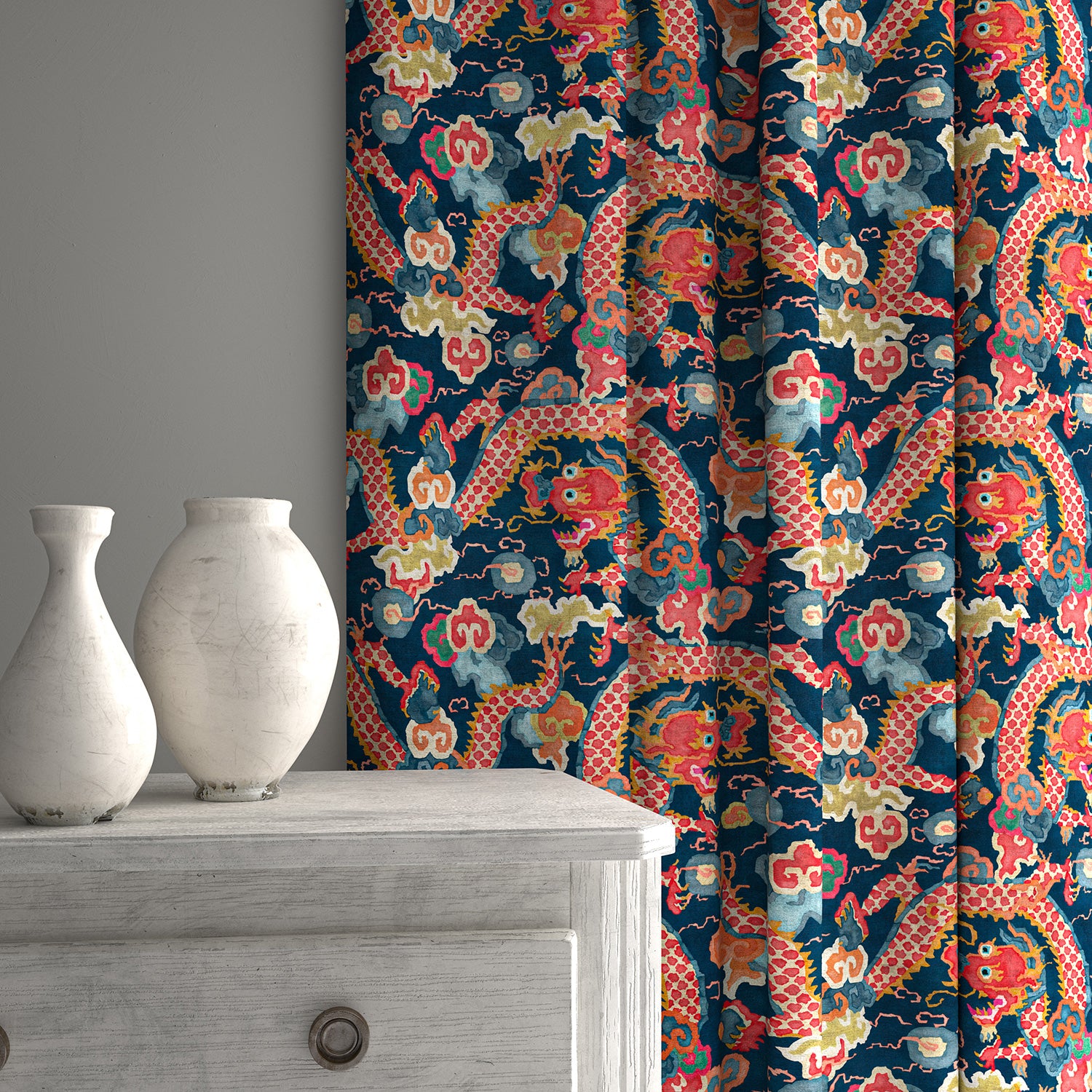 Velvet curtains upholstered in a printed velvet fabric with a intricate mirror dragon design in blue and orange colours.