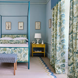 Headboard and curtains in a printed linen fabric with tree of life design in blue and green colours.