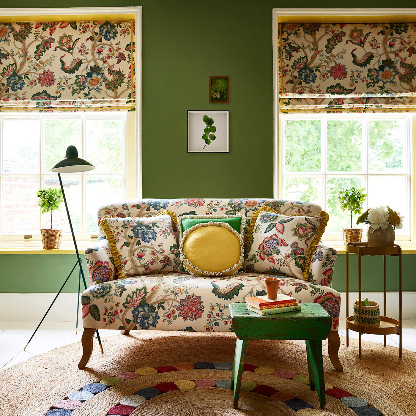 Sofa in a printed linen fabric with tree of life design in multicolours.