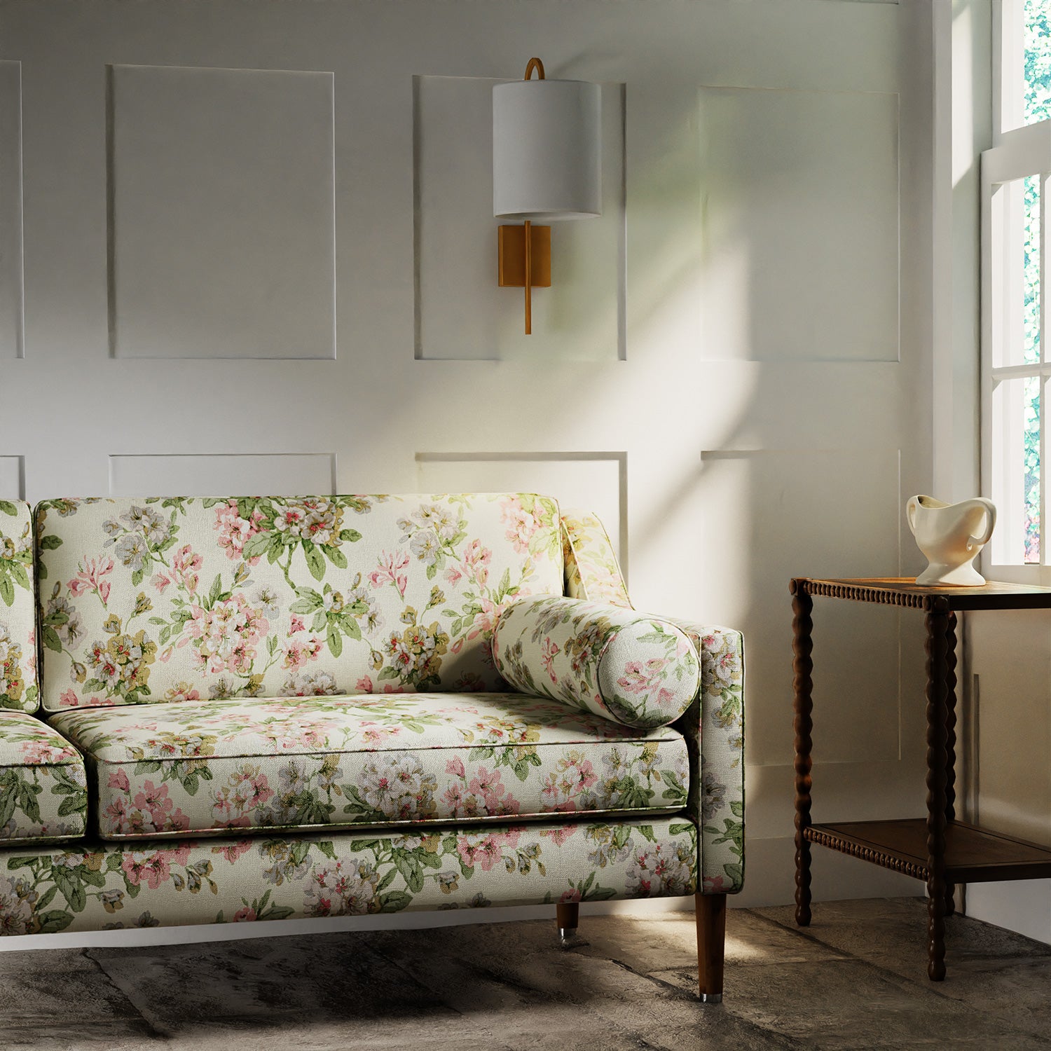 Sofa covered in a printed linen fabric with floral pattern in white, green and pinks.