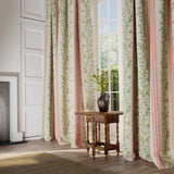 Curtains in a printed linen fabric with pink and green stripes and an oak-leaf motif.
