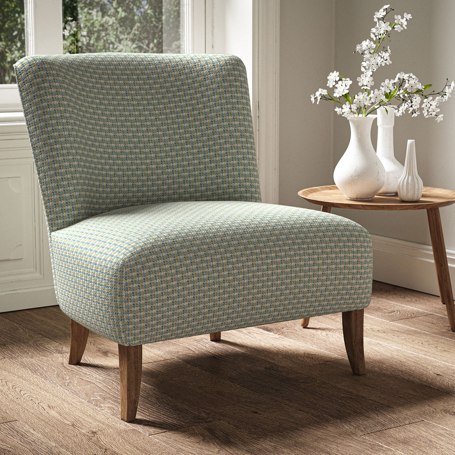 Armchair in a printed linen fabric with textural weave pattern in blue and yellow colours.
