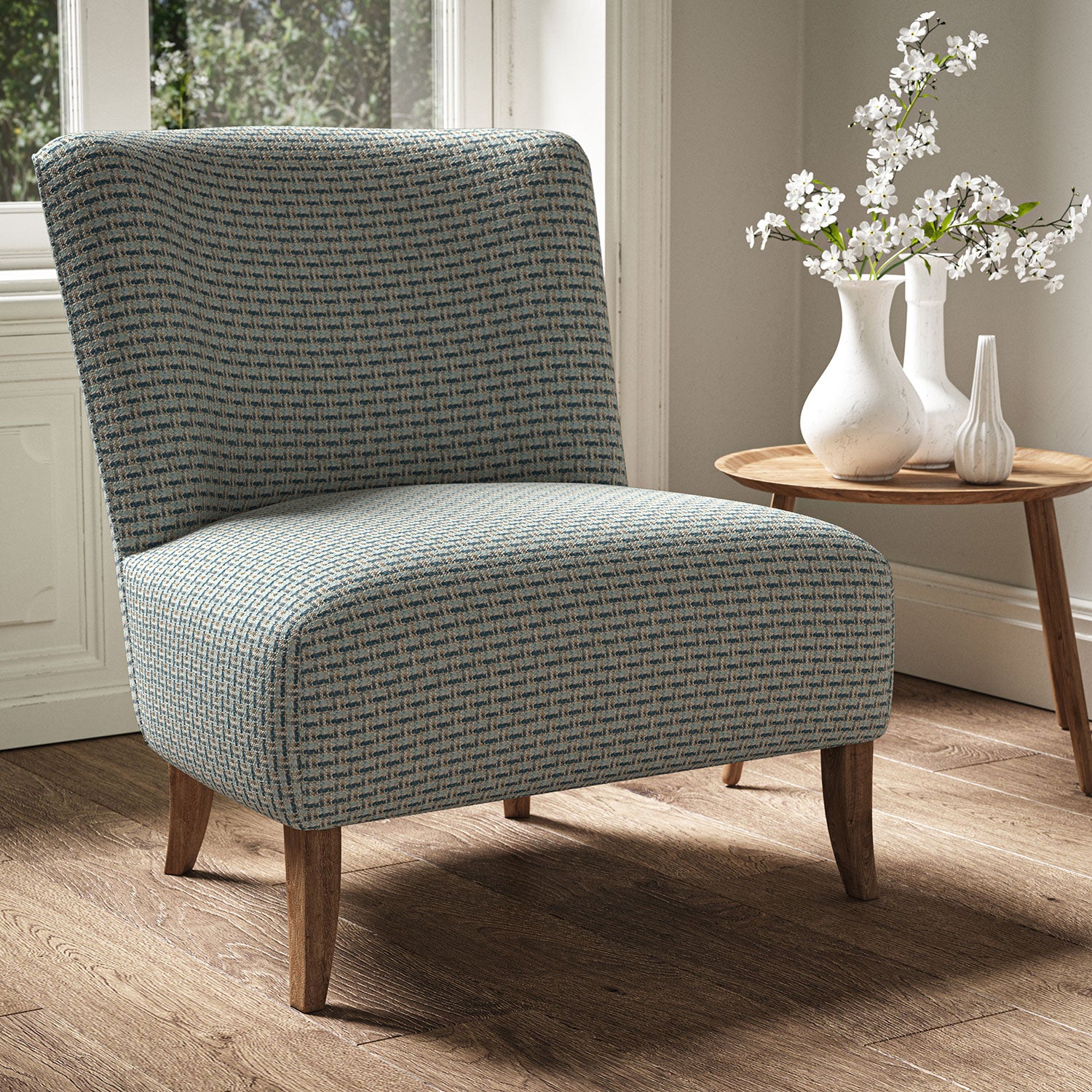 Armchair in a printed linen fabric with textural weave pattern in blue colours.