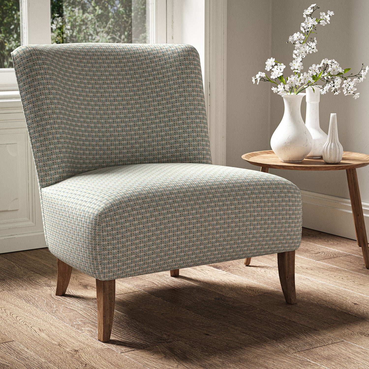 Armchair in a printed linen fabric with textural weave pattern in brown and blue colours.